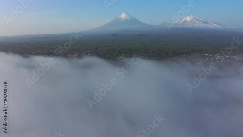 Drone aerial video view of the mountain volcano valley, summer day, blue sky, road photo