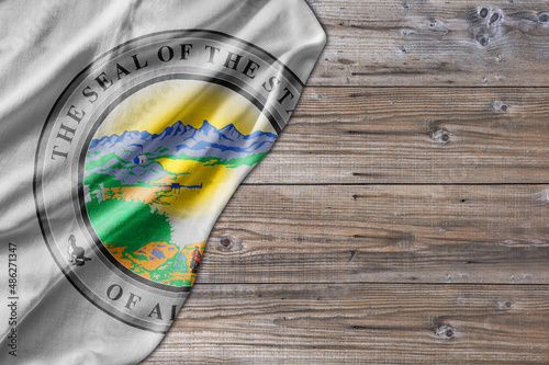 United States country state Seal Alaska on old wooden pattern table board
