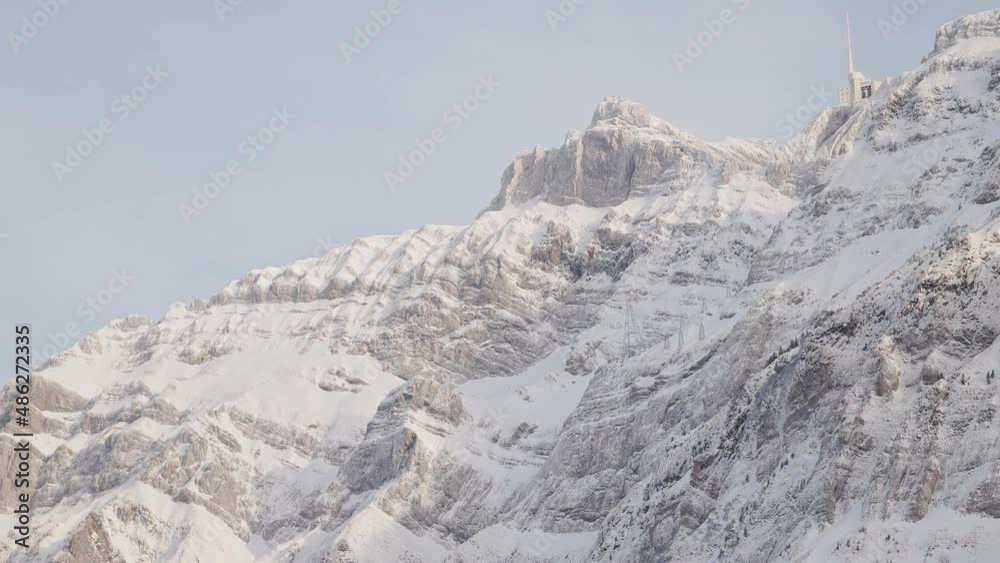 Swiss Mountain Saentis in the alps with fresh snow and fog. Beautiful snowy mountains and trees. Weather station on top of the mountain. Swiss Mountain Saentis in the alps with fresh snow and fog. Beautiful snowy mountains and trees. Weather station on top of the mountain.
