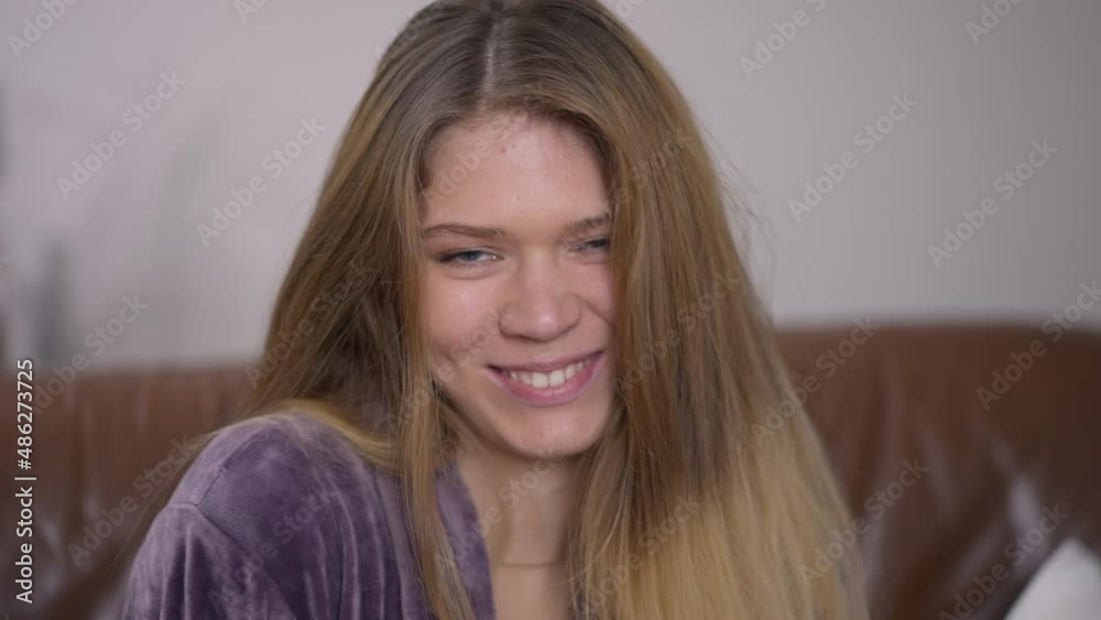 Close-up confident young Caucasian woman looking at camera with seductive facial expression laughing out loud. Headshot portrait of relaxed beautiful millennial lady having fun posing indoors Close-up confident young Caucasian woman looking at camera with seductive facial expression laughing out loud. Headshot portrait of relaxed beautiful millennial lady having fun posing indoors