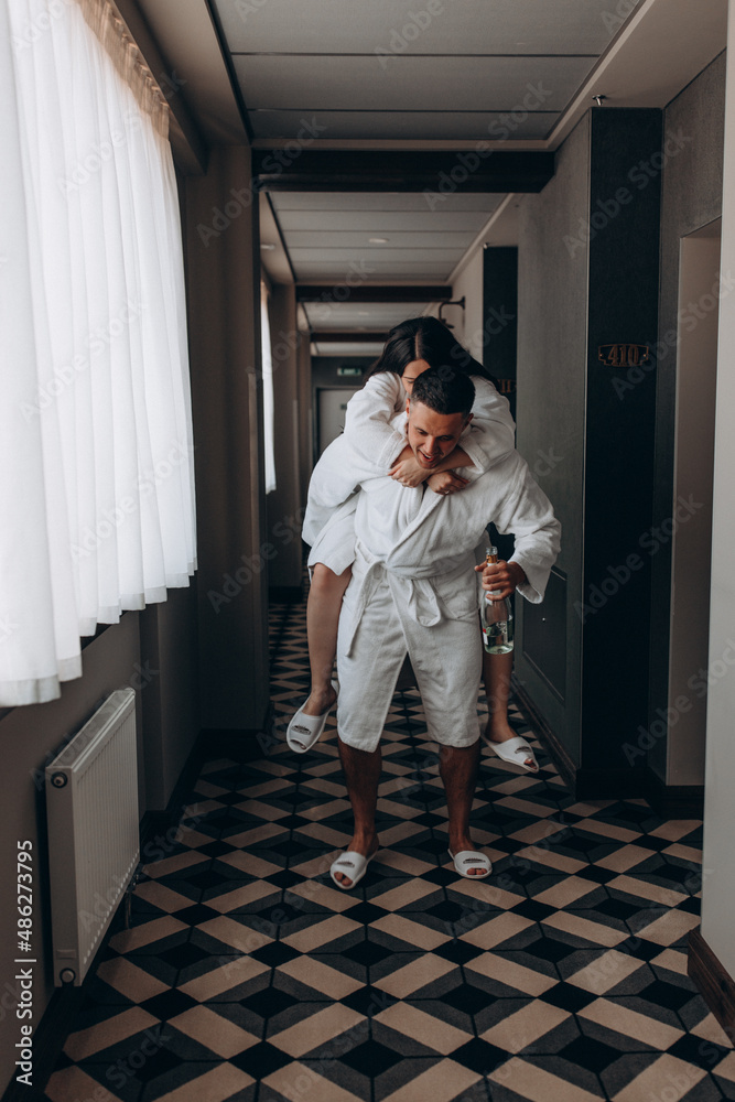 Husband and wife together in a hotel. Photo session of a couple in love in the hallway. Honeymoon.