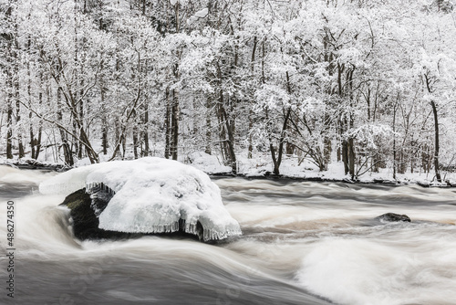 Ice on stone in winter river photo