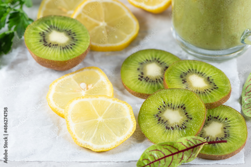 Healthy Food Background. Sliced fruits on a gray stone background. Citrus, orange, lemon, kiwi, green leaves. Raw food diet. Healthy Food Background. Sliced fruits on a gray stone background. Citrus, orange, lemon, kiwi, green leaves. Raw food diet.