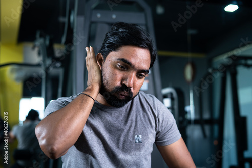 close up shot of young man with washing sweat after heavy workout at gym - concept of tireless hardworking, relaxing, taking break and determination