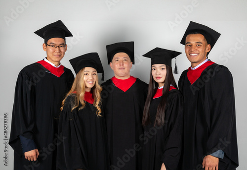 Group of graduate students friends pose together excitedly