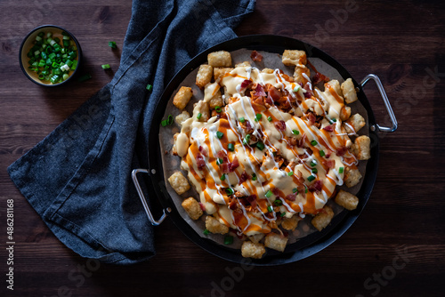 Top down view of tater tot poutine fresh out of the oven, ready for sharing.