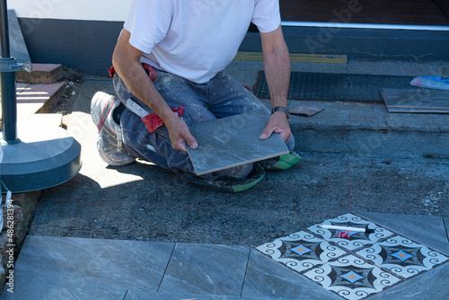 Man laying floor tiles