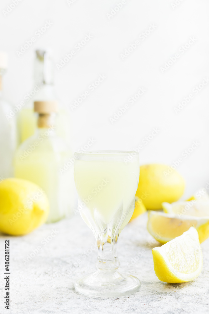 Italian traditional liqueur limoncello with lemon Italian traditional liqueur limoncello with lemon