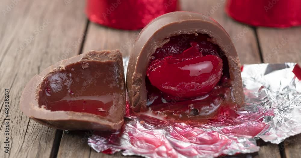 Cherry filled chocolate candy with candies packed in red foil paper