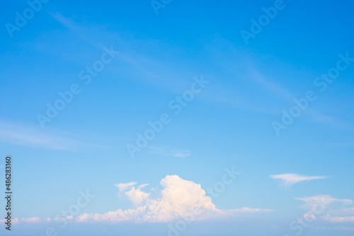 Blue sky with small white clouds for background usage. with copy space on top.