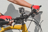 Waterproof action camera on bike handlebars. light wall background.
