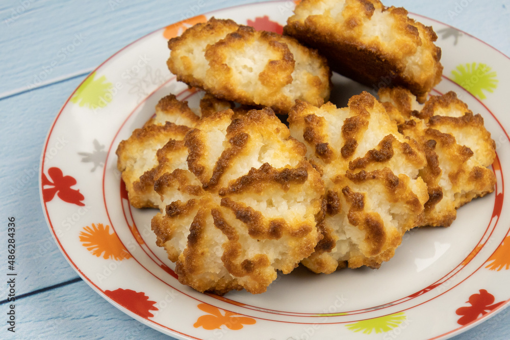 Homemade coconut cookies on plate on table Homemade coconut cookies on plate on table
