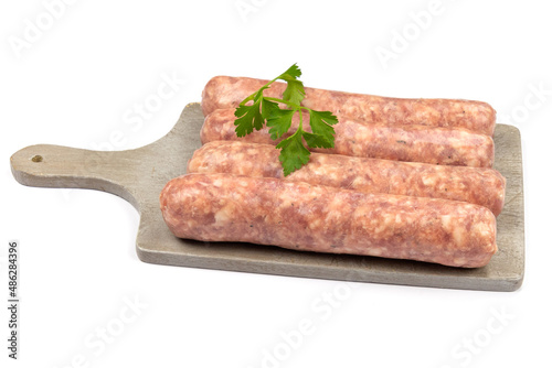 raw sausages on wooden board isolated on white background