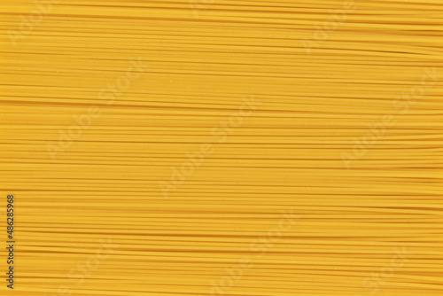 background with uncooked italian spaghetti, close up