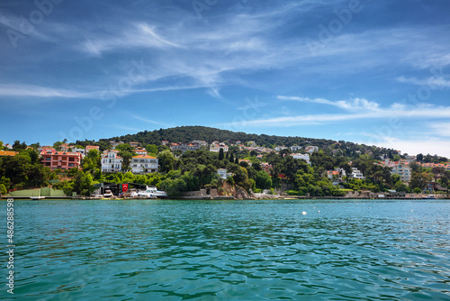 View of the sea and the coast of the island with residential buildings. Travel to Buyukada, Adalar, Prince Islands, Istanbul, Turkey © Dmitriy