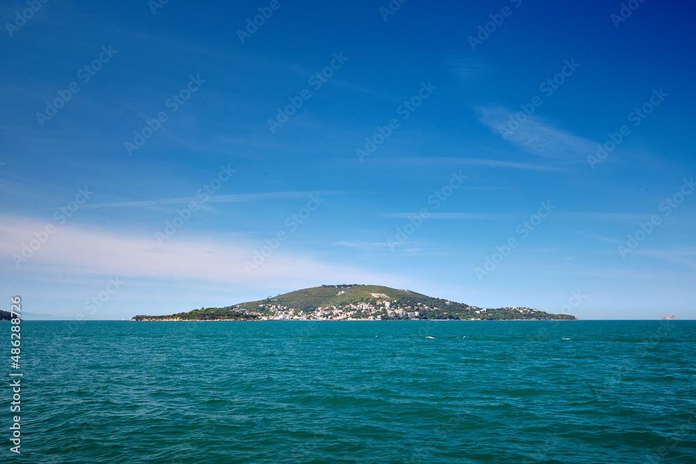 Island with houses in the sea, Blue sea and blue sky. The Sea of Marmara, Burgazada, Prince Islands, Istanbul, Turkey