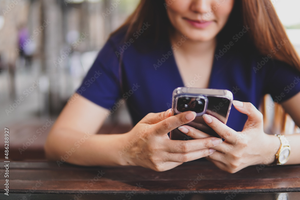 Close up of women use smart phone in restaurant Close up of women use smart phone in restaurant