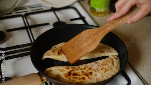 Cooking Kutaba or gozleme - cakes stuffed with cottage cheese on a plate. Vegan food. photo