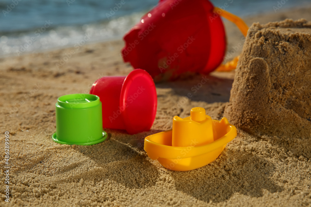 Set of plastic beach toys on sand near sea. Outdoor play Set of plastic beach toys on sand near sea. Outdoor play