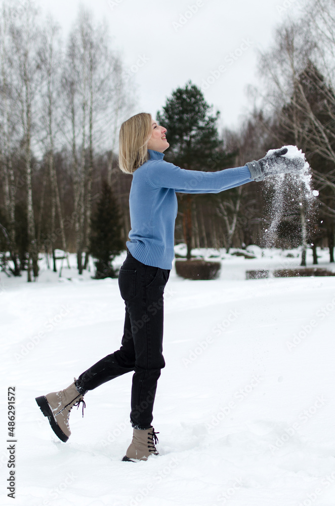 woman playing with snow