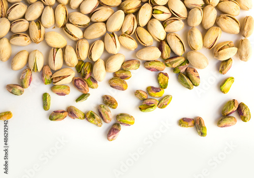 roasted pistachio nuts on a white background and place for inscription
