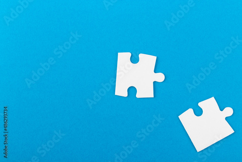 Jigsaw puzzle pieces on blue background.