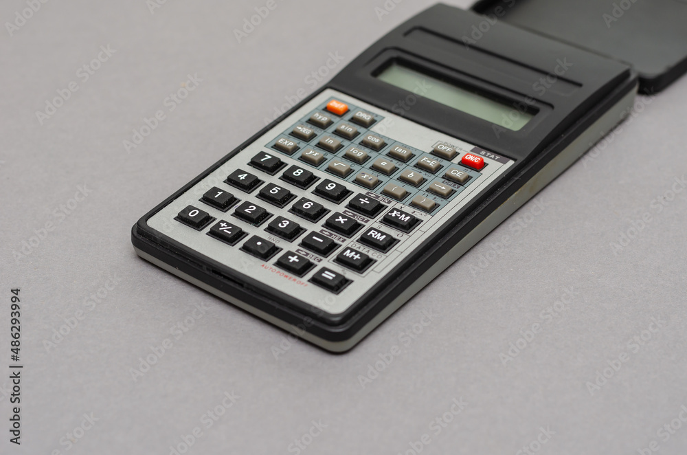 Scientific calculator against gray background. Scientific calculator against gray background.