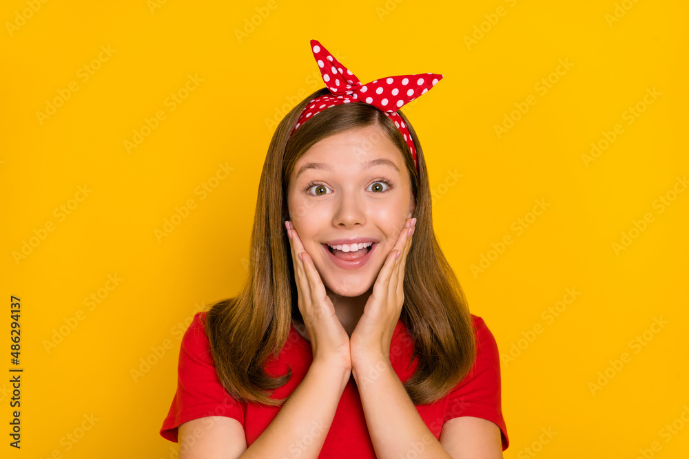 Portrait of adorable sweet positive lovely little woman touch cheekbones see ad banner isolated on yellow color background Portrait of adorable sweet positive lovely little woman touch cheekbones see ad banner isolated on yellow color background