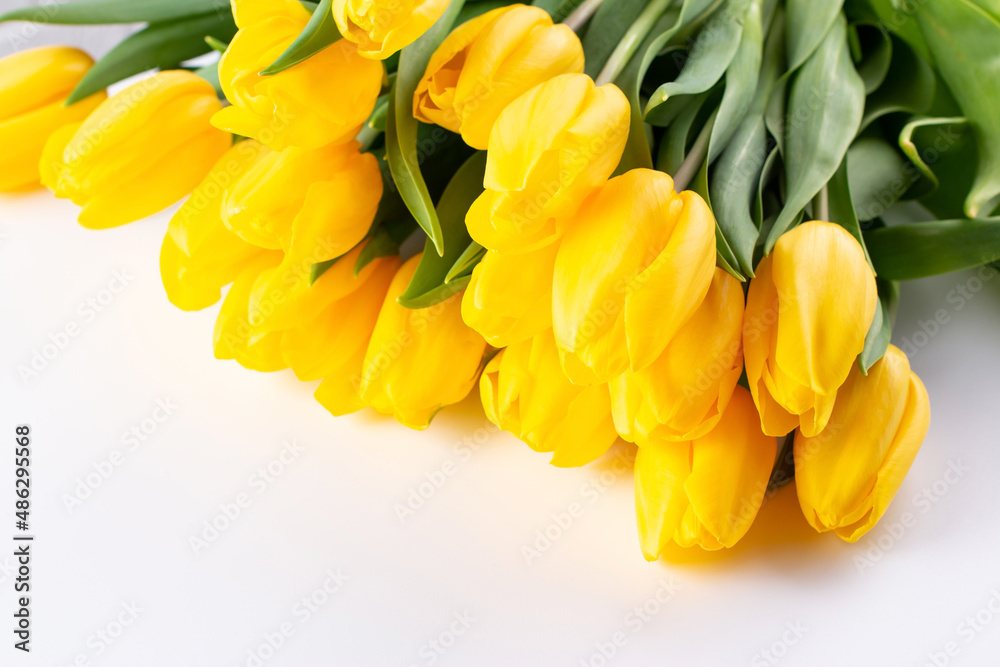 Yellow tulips flowers bouquet on a light background. Valentines Day, Mothers Day, and Birthday celebration concept. Yellow tulips flowers bouquet on a light background. Valentines Day, Mothers Day, and Birthday celebration concept.