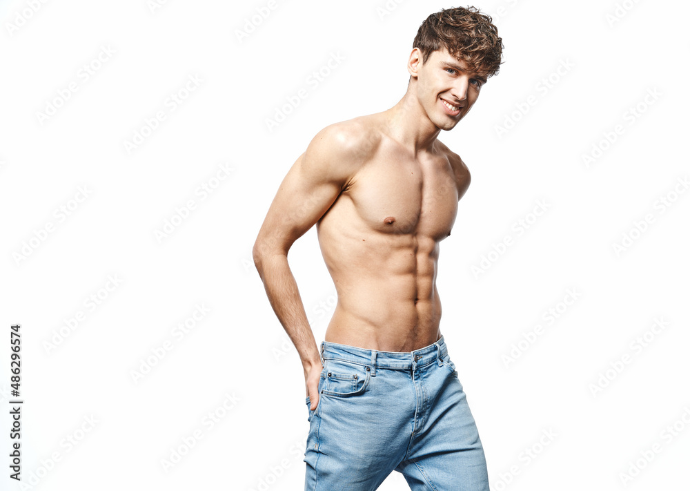 Portrait of sexy man in blue jeans isolated on white background