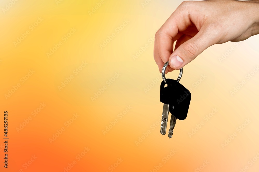 Hand showing giving car key as gift Hand showing giving car key as gift