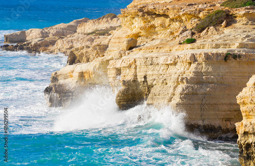 Ocean waves splash against beach with rocks background, Cliffs in the sea, Top aerial view of Cyprus, Nature Background with Sea, Vacation and relax
