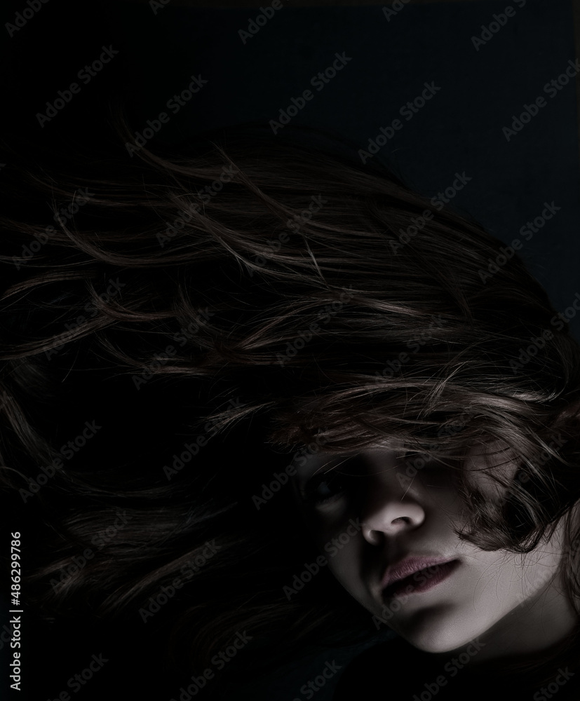 Portrait of a young girl in the dark