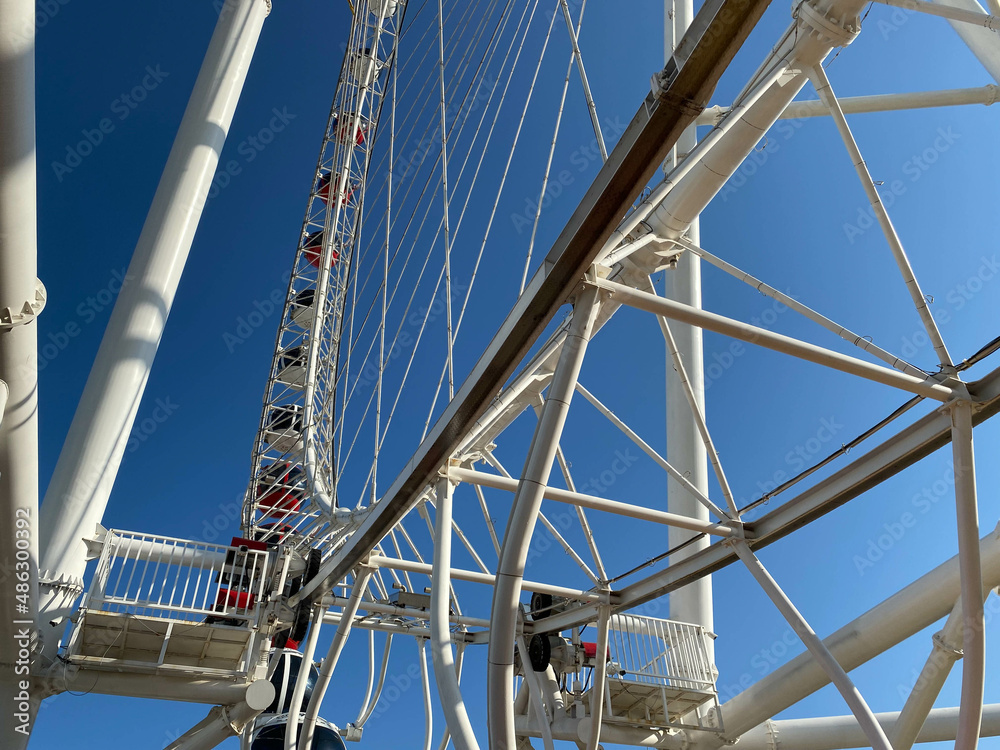 Photo From the bottom up a fragment of a modern Ferris wheel with booths against the sky
