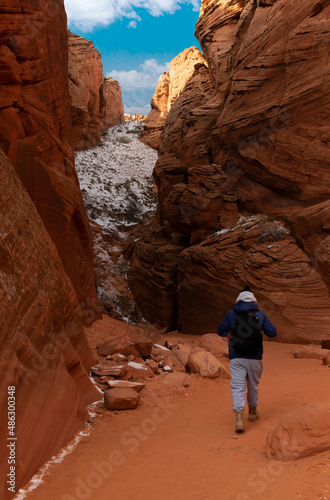 Young man walking among canyons, Antelope Canyon