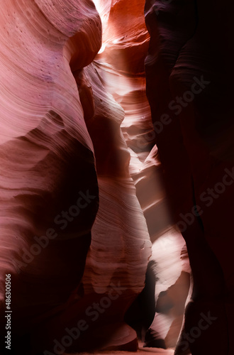 Beautiful sun ray entering red and orange rock formation at antelope canyon