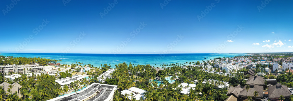 Caribbean coastline of Atlantic ocean with luxury resorts, palm trees and azure water. travel destination. Aerial panorama view