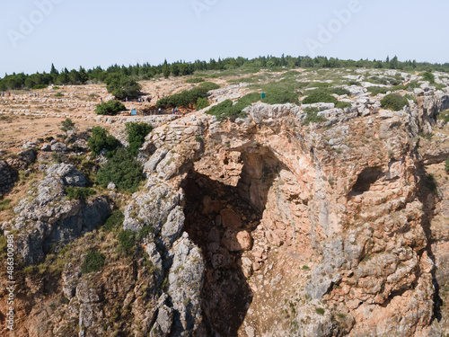 The Keshet  Cave - ancient natural limestone arch spanning the remains of a shallow cave with sweeping views near Shlomi city in Israel © svarshik