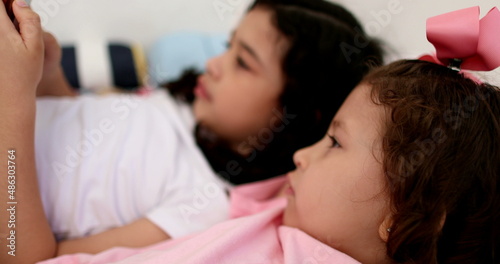 Female children siblings using cellphone