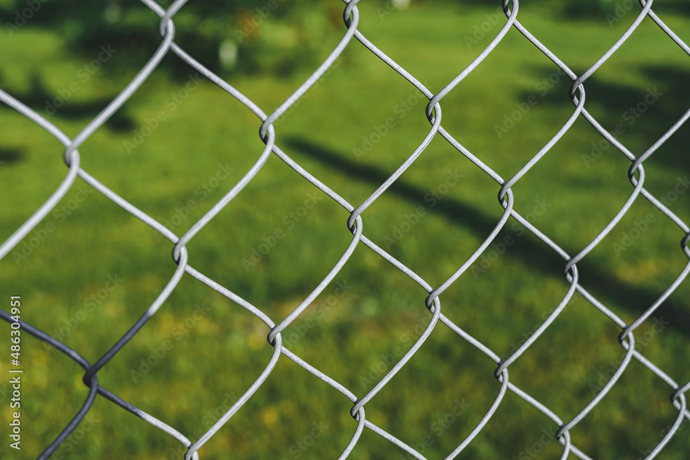 Close up, steel wire mesh fence. Against the backdrop of nature. Close up, steel wire mesh fence. Against the backdrop of nature.