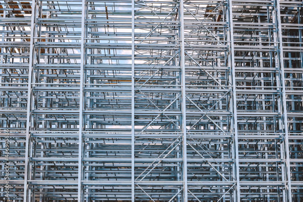 Structure of a new steel frame of a building on an industrial construction site.