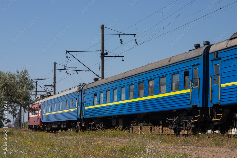 Old blue passenger train, carriages on a sunny summer day