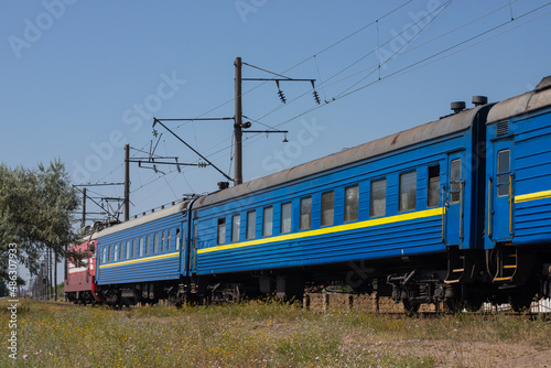 Old blue passenger train, carriages on a sunny summer day