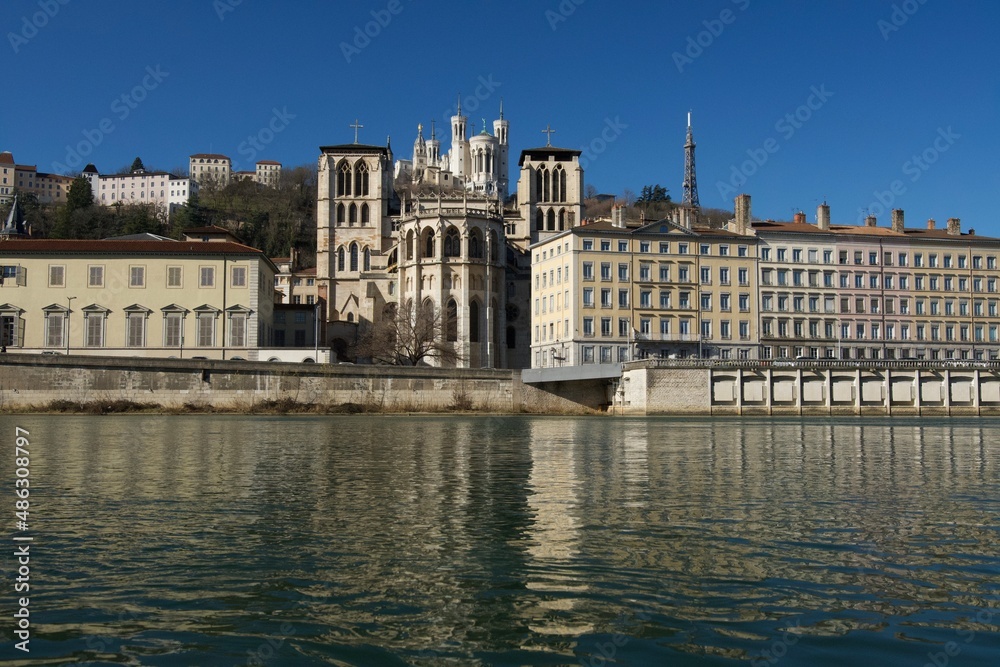 Impressive basilica Notre Dame de Fourviere overlooking the beautiful cathedral Saint Jean Baptiste and all reflected in the river Saone.