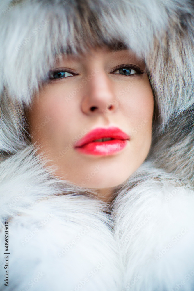 Russian girl in a fur hat, beautiful red lips and blue eyes, premium Russian girl in a fur hat, beautiful red lips and blue eyes, premium