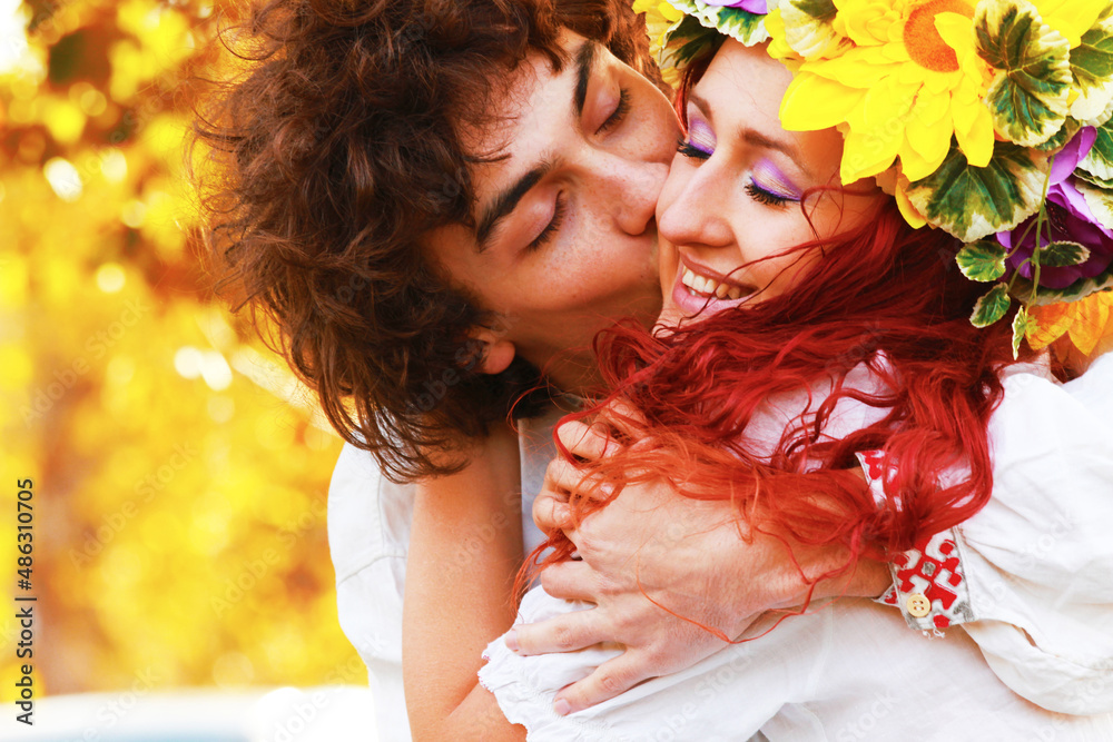 Fototapeta premium Wedding in traditional costumes of Slavic peoples. People in Ukrainian, Polish, Slovak, Hungarian national clothes. A girl with a wreath on her head. Happy couple in nature