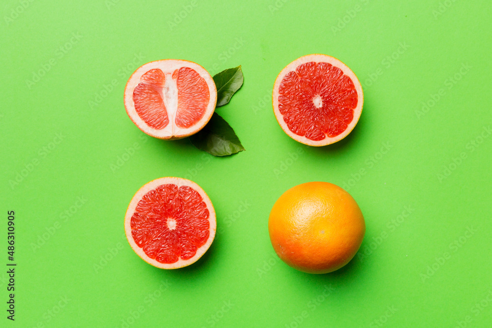 fresh Fruit grapefruit with Juicy grapefruit slices on colored background. Top view. Copy Space. creative summer concept. Half of citrus in minimal flat lay with copy space fresh Fruit grapefruit with Juicy grapefruit slices on colored background. Top view. Copy Space. creative summer concept. Half of citrus in minimal flat lay with copy space