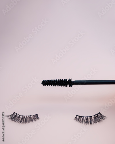 Fake eyelashes on pastel pink background. Beauty concept. Makeup cosmetics. Top view, flat lay. Layout. Place for text and design. Web Banner. Minimal style