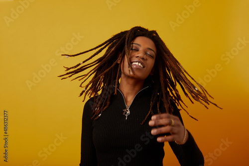 Canvas-taulu Studio portrait of woman with dreadlocks against yellow background