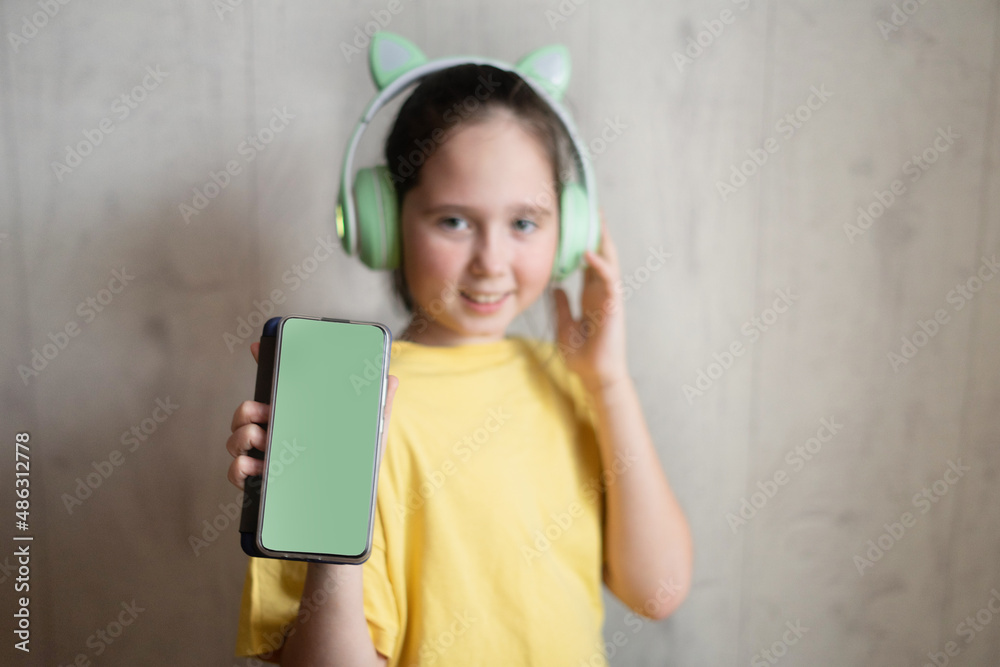 The child girl in wireless bright Modern headphones The child girl in wireless bright Modern headphones